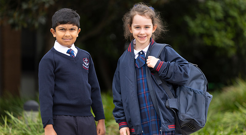 Two students wearing the new school uniform