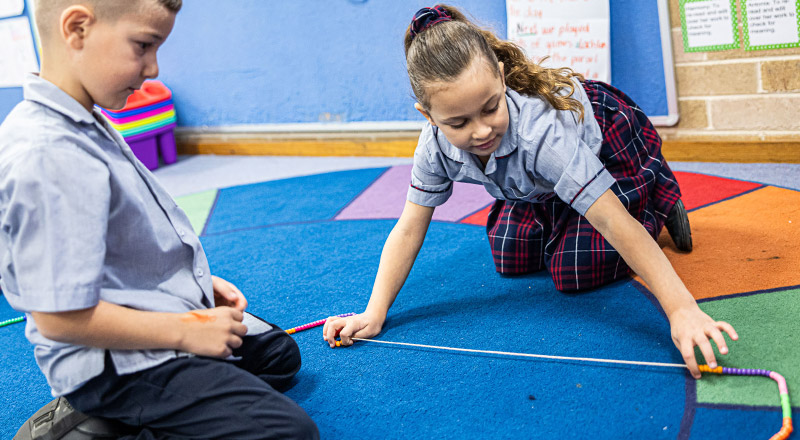 Sacred Heart Catholic Primary School Westmead students learning maths using a bead string