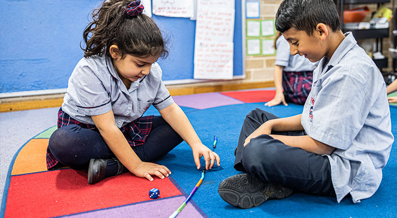 Sacred Heart Catholic Primary School Westmead students learning maths using a bead string