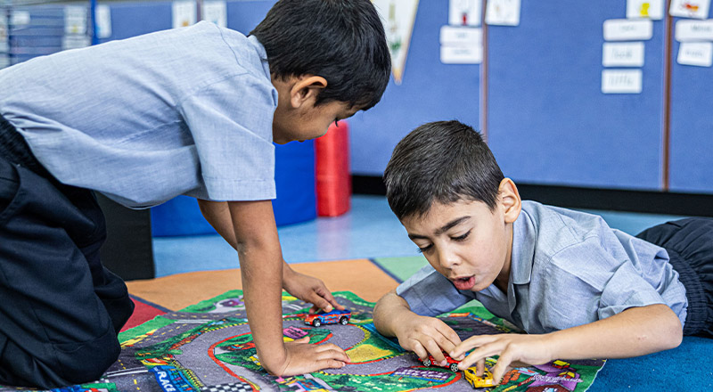 Sacred Heart Catholic Primary School Westmead students playing with toy cars on a rug