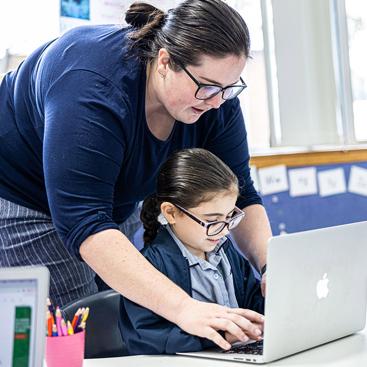Sacred Heart Catholic Primary School Westmead student with dedicated teacher on laptop