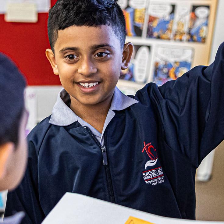 Sacred Heart Catholic Primary School Westmead student grinning at other student